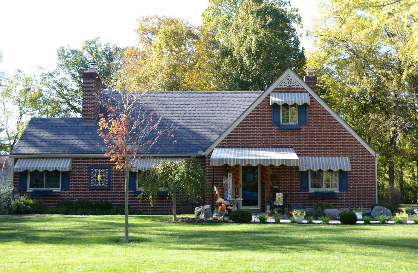 Brick home with a green lawn in autumn